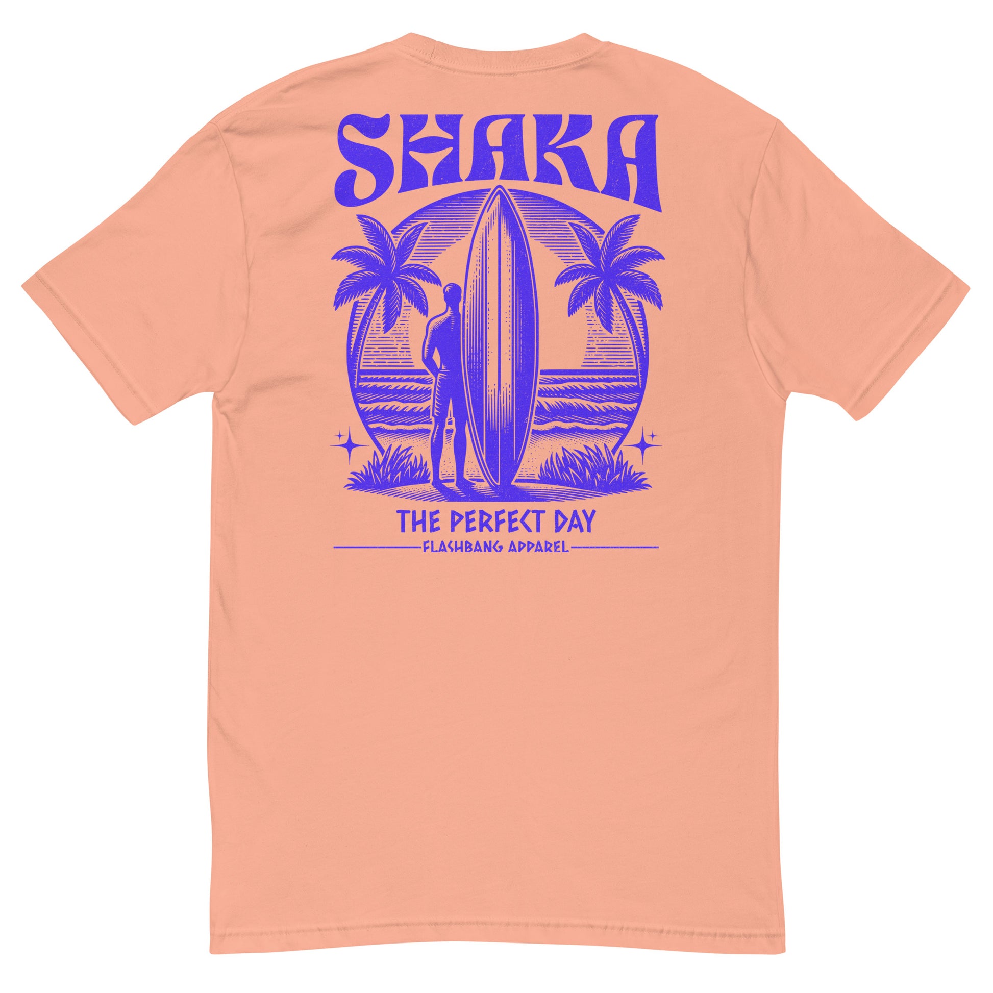 Peach t-shirt with purple 'Shaka The Perfect Day' graphic on a white background