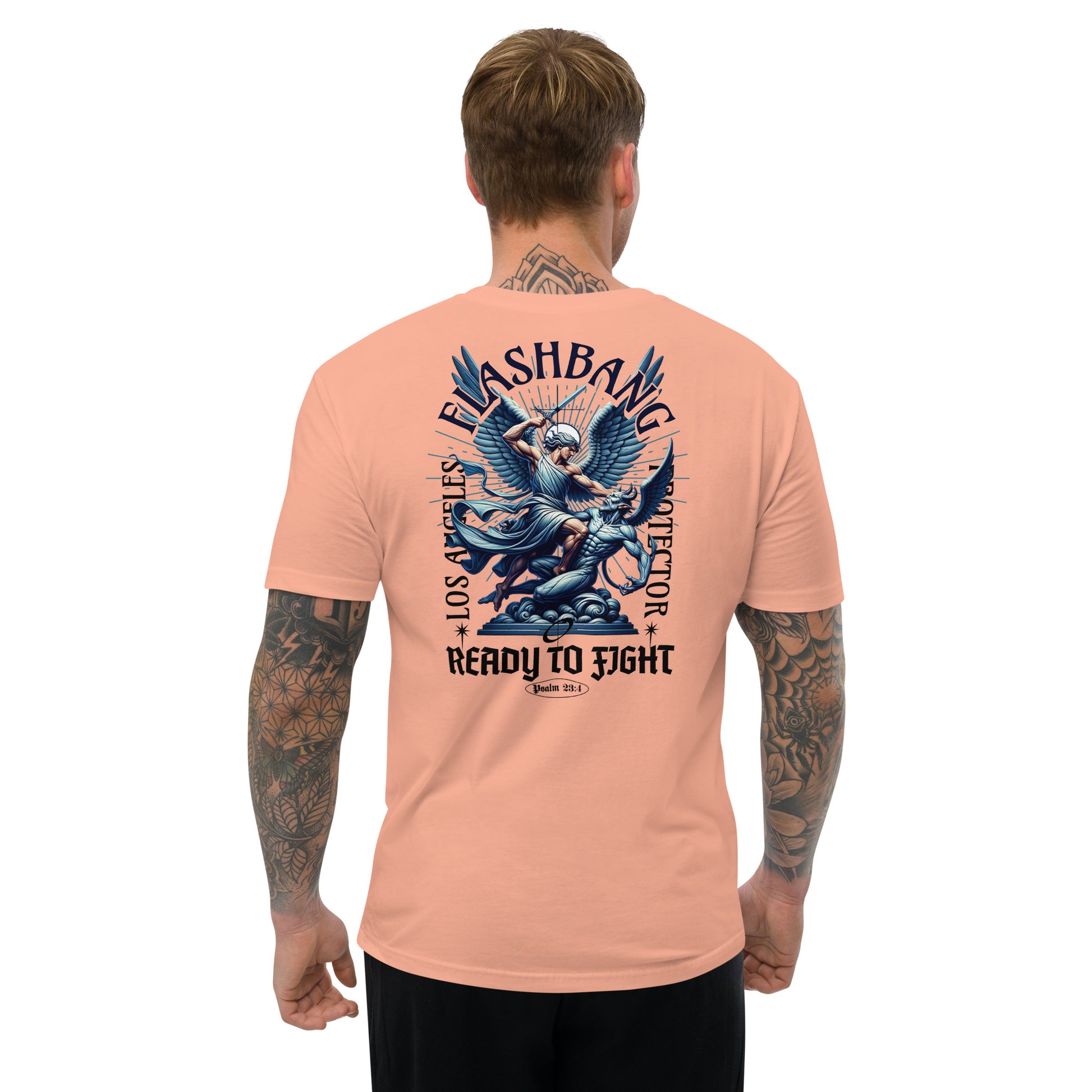 Man wearing a peach t-shirt with a graphic design on the back, standing against a white background.