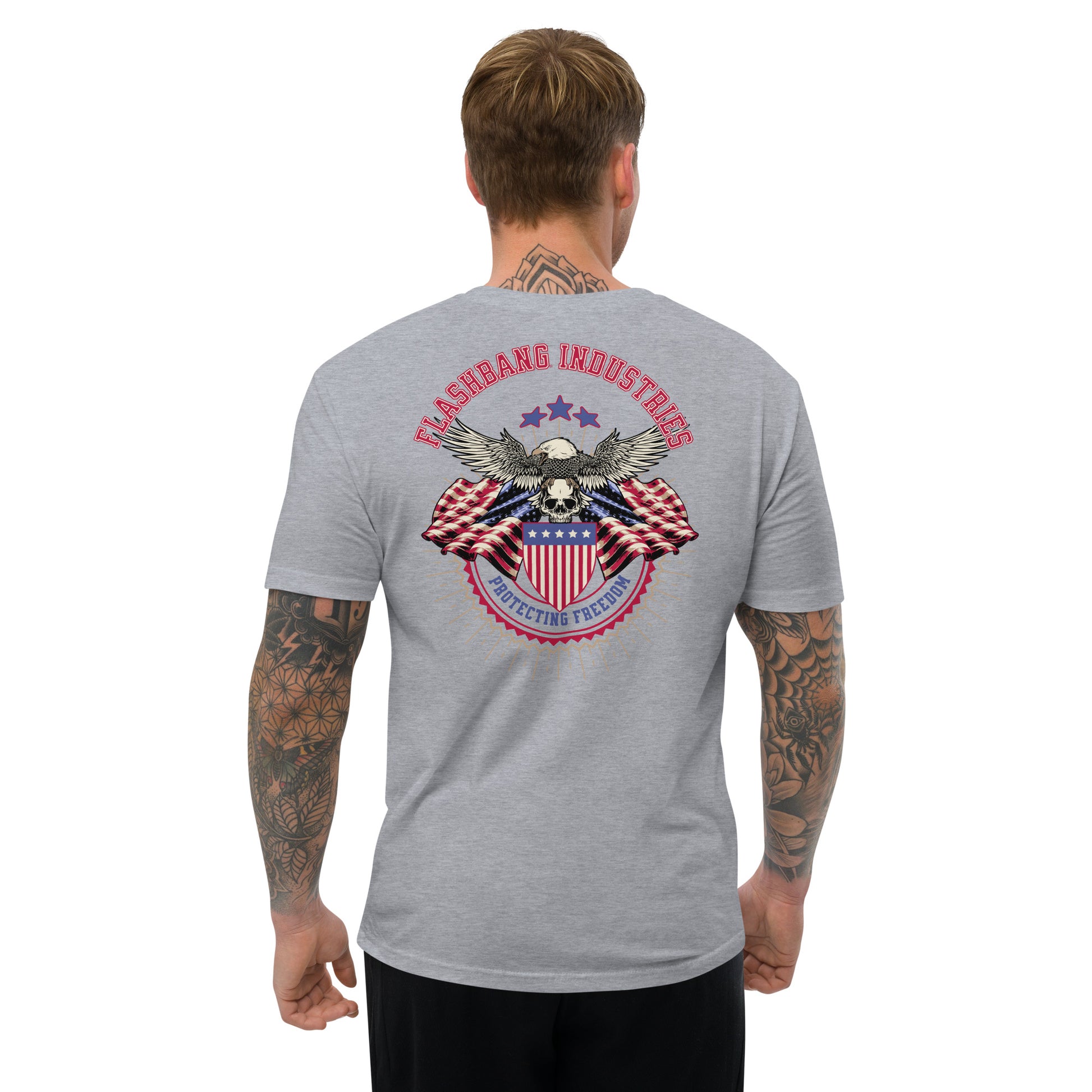 Man wearing a gray t-shirt with a graphic design on the back, featuring an eagle and American flag.