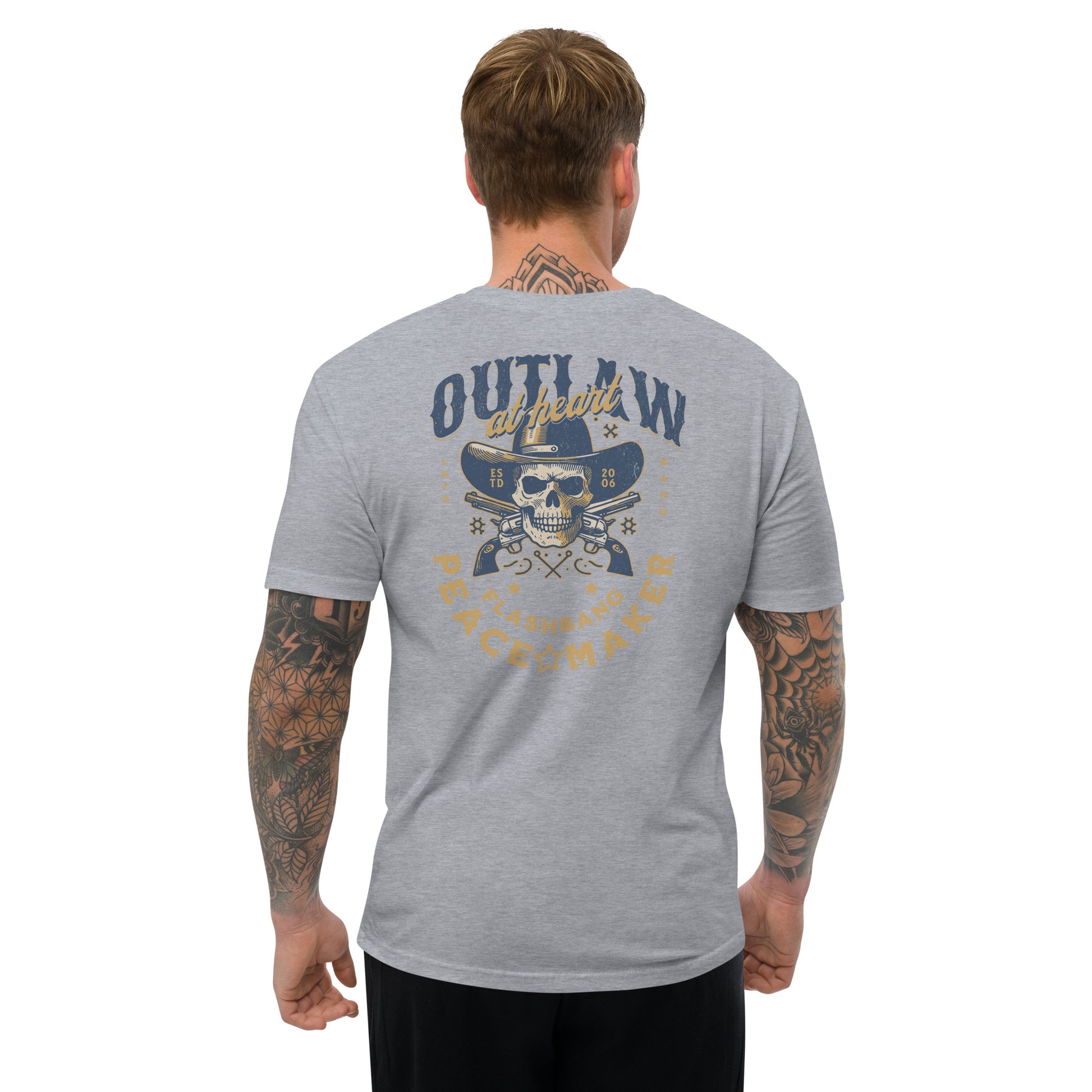Man wearing a gray t-shirt with a skull and crossbones design on the back, on a white background.