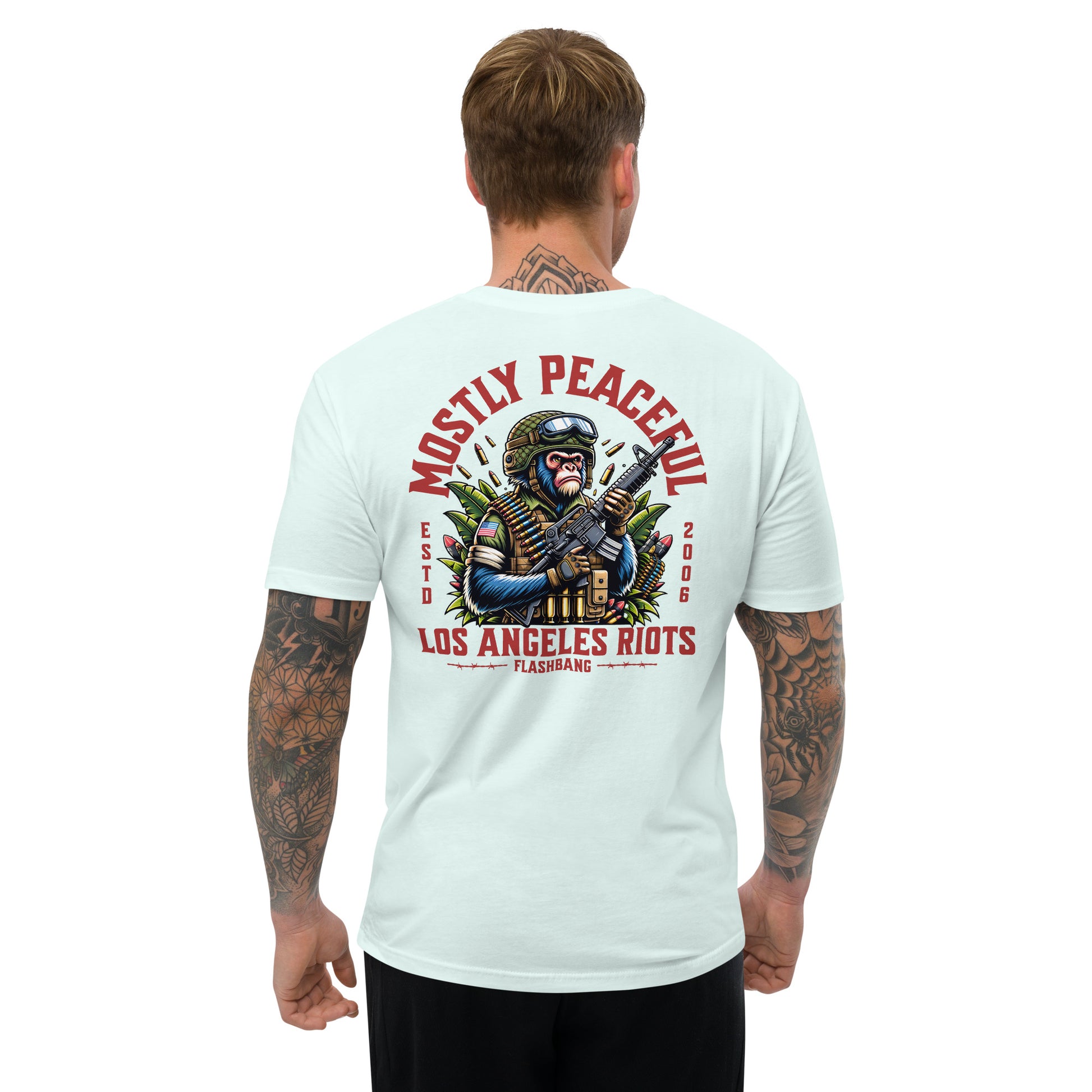 Man wearing a light blue t-shirt with a graphic design and text on the back, on a white background.