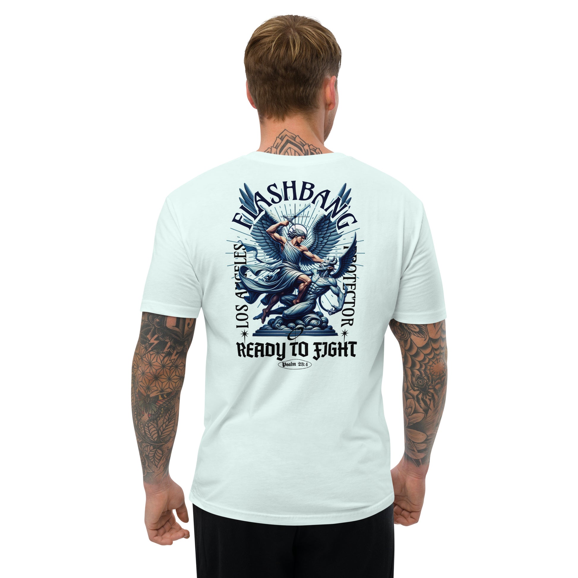 Man wearing a light blue t-shirt with a graphic design on the back, standing against a white background.