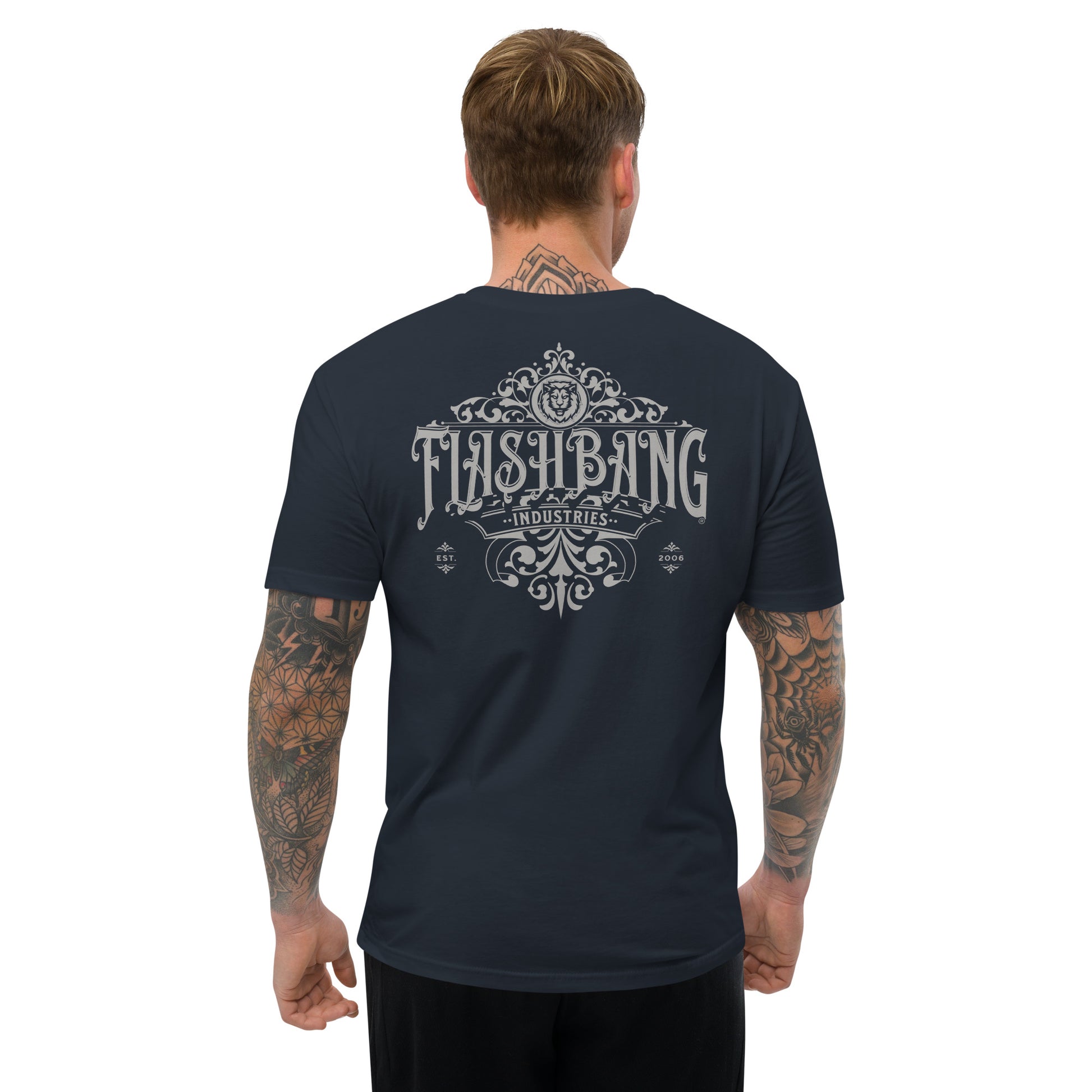Man wearing a navy blue t-shirt with 'Flashbang Industries' design on the back, on a white background.