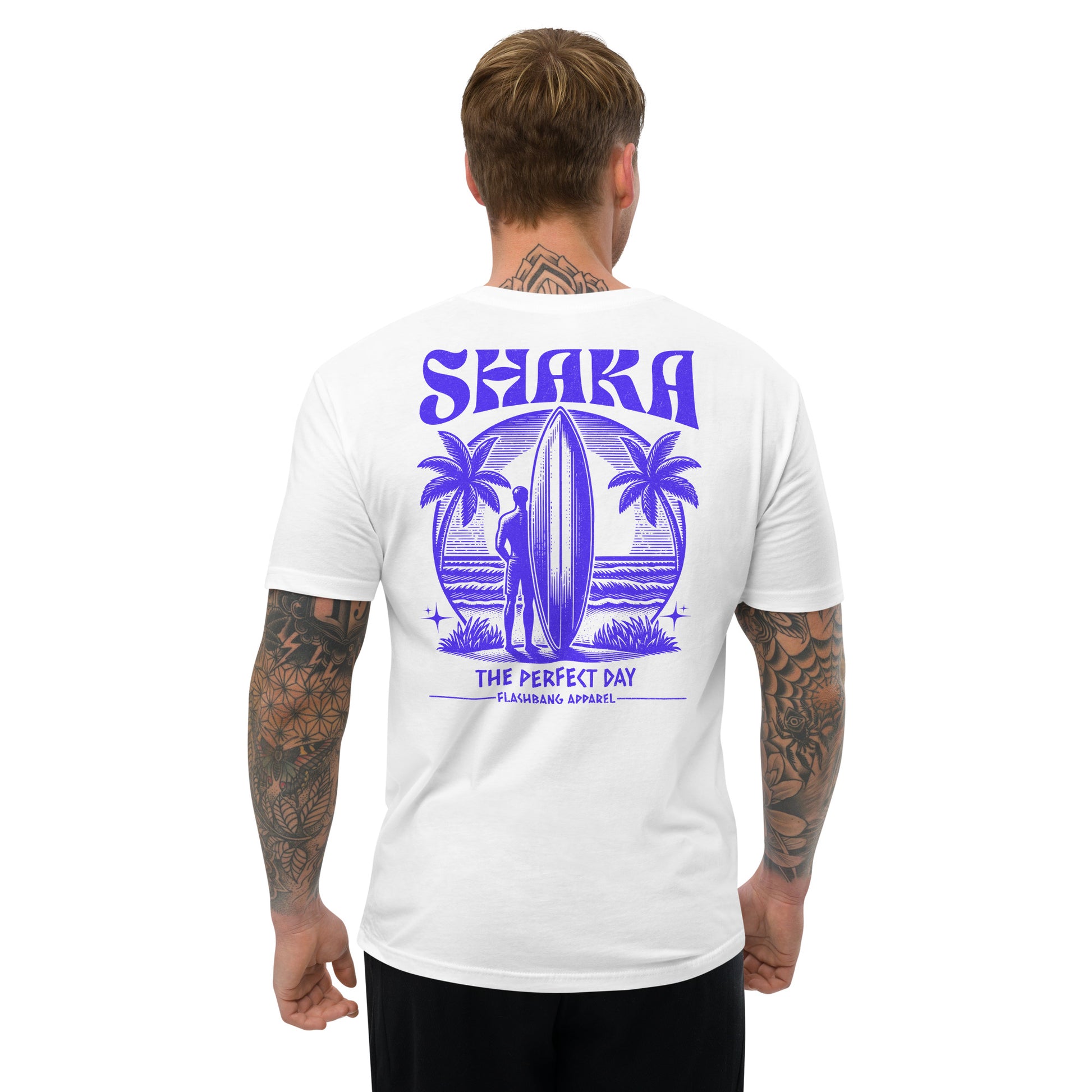 Man wearing a white t-shirt with purple 'Shaka' design on the back, standing against a white background.