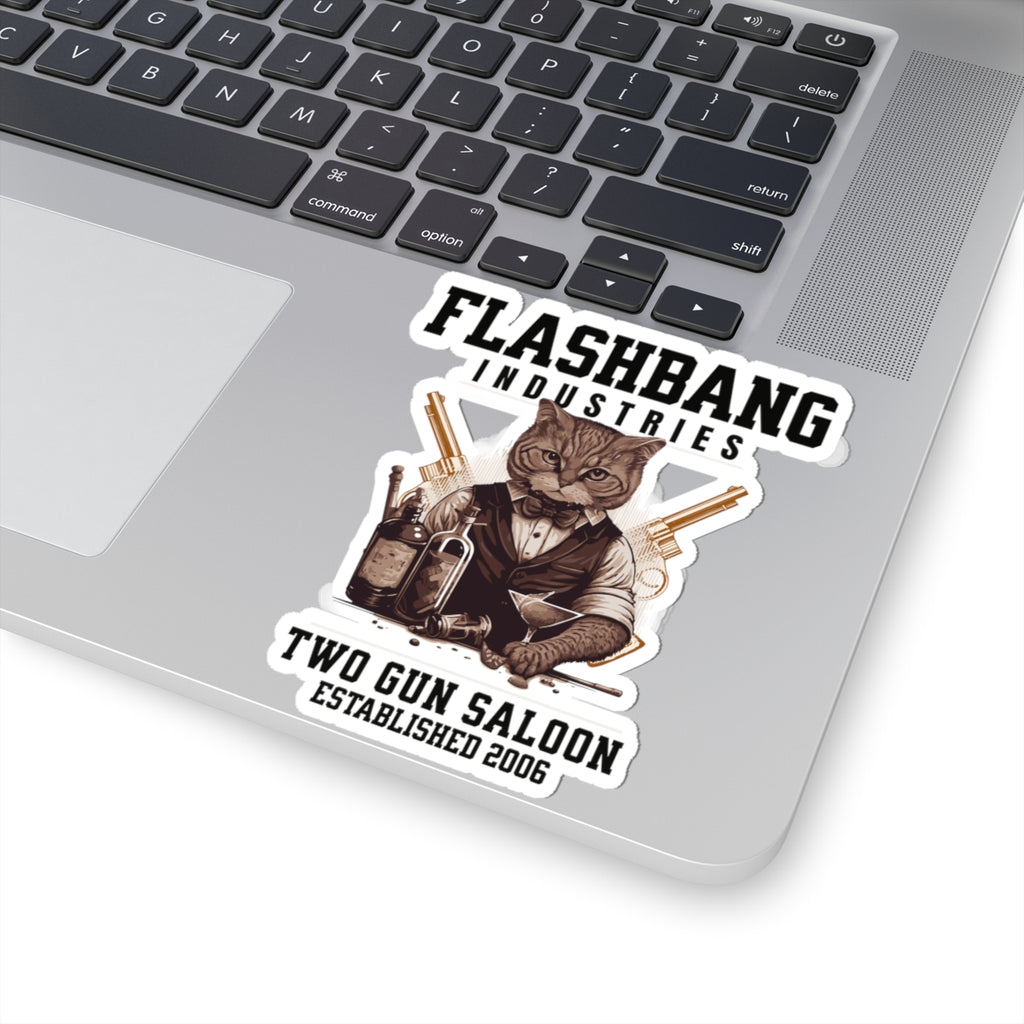 Laptop with a 'Flashbang Industries' sticker featuring a cat in a tuxedo with guns.