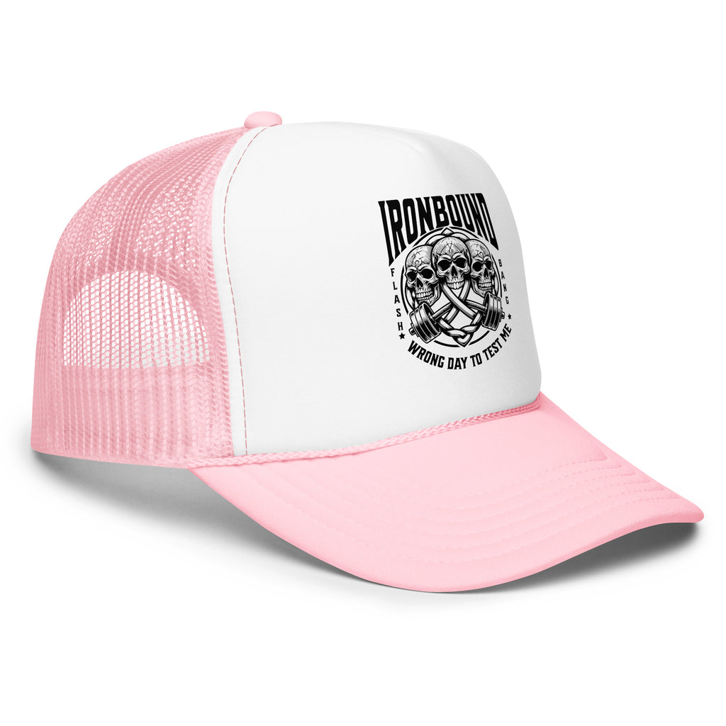 Pink and white trucker cap with skull design and text on a white background