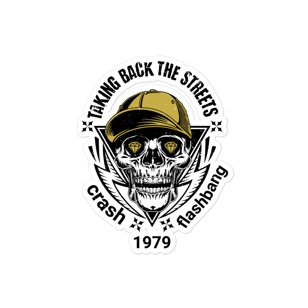Sticker with skull wearing a cap and text 'Taking Back the Streets Crash Flashbang 1979' on a white background