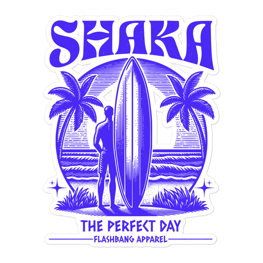 Sticker with a surfer holding a surfboard, palm trees, and 'SHAKA THE PERFECT DAY' text on a white background.