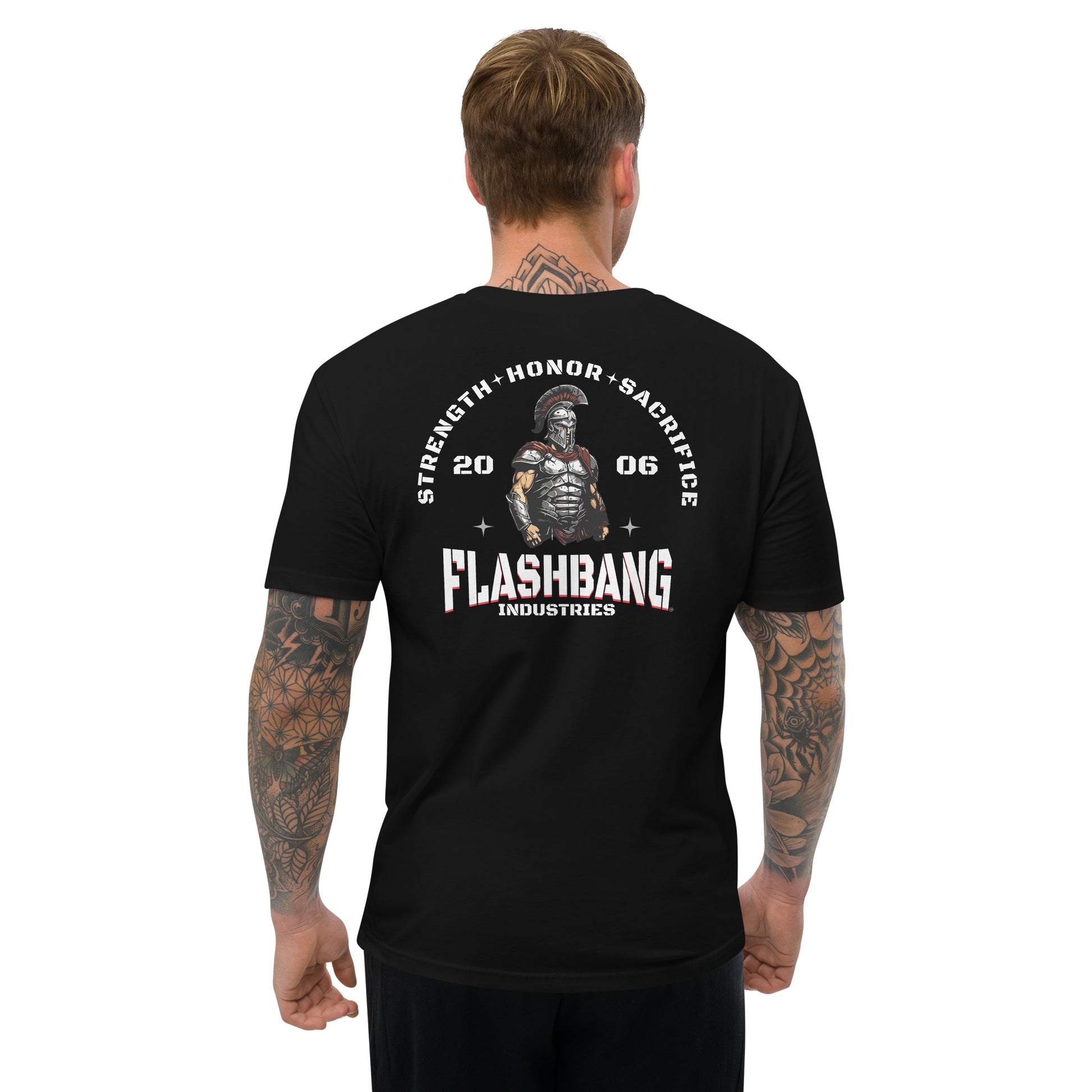 Man wearing a black t-shirt with 'Flashbang Industries' design on the back, standing against a white background.