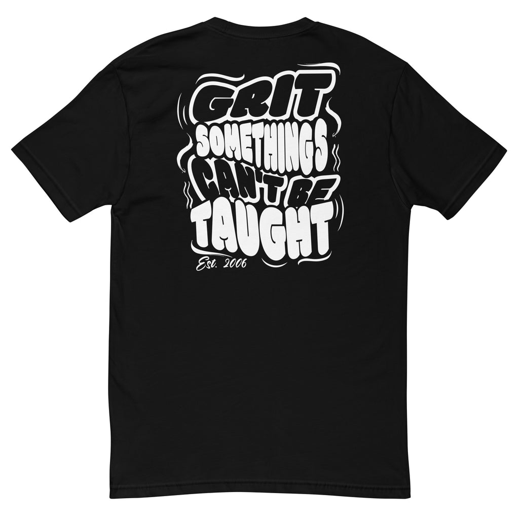Black t-shirt with white text 'GRIT SOMETHINGS CAN'T BE TAUGHT' on a white background