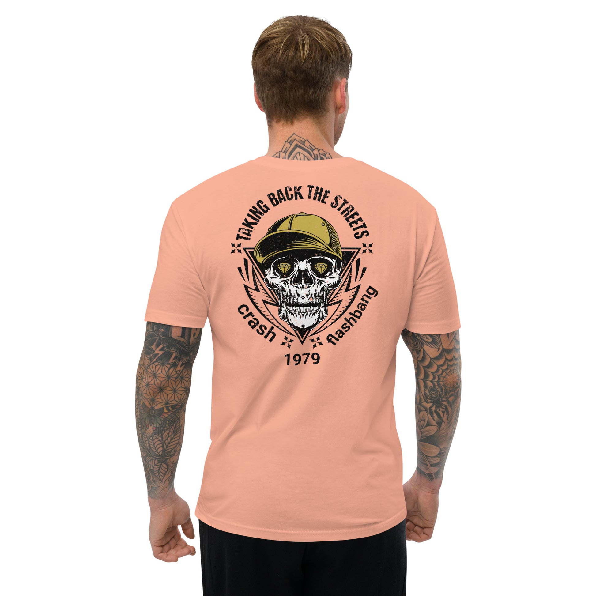 Person wearing a peach t-shirt with a skull graphic and text on the back, on a white background