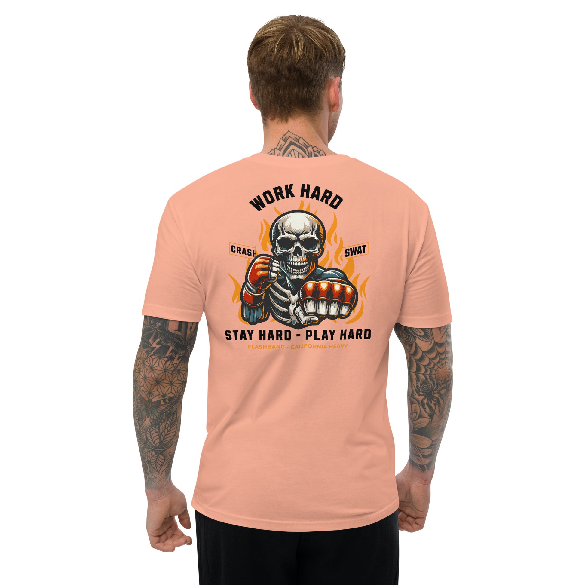 Man wearing a peach t-shirt with a graphic design and text on the back.