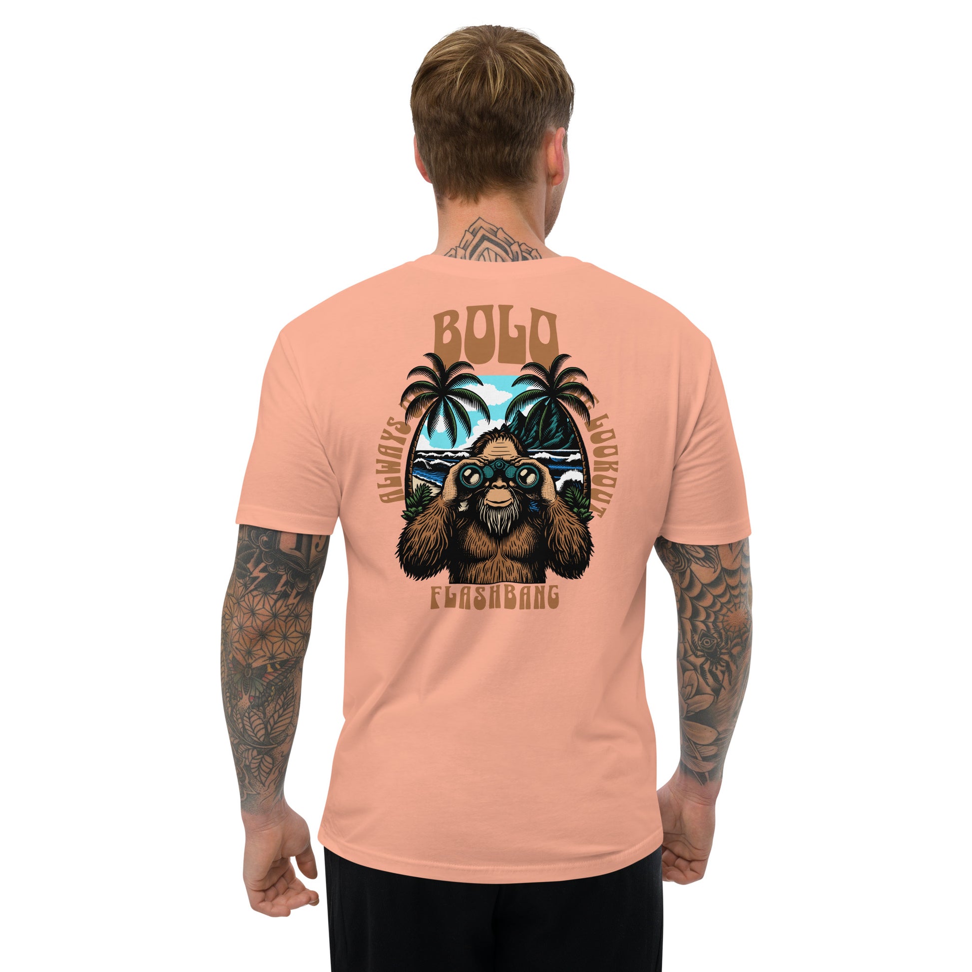 Man wearing a peach t-shirt with a graphic design on the back, standing against a white background.