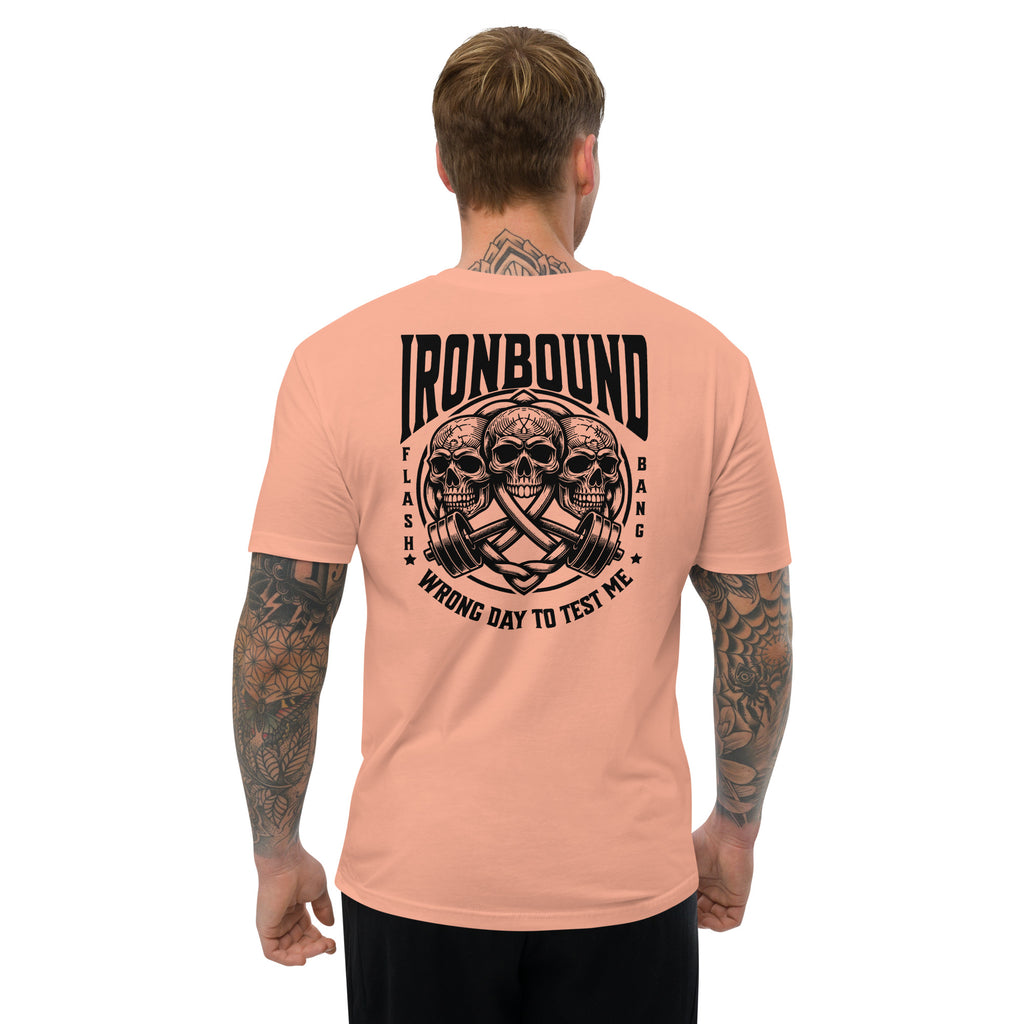 Man wearing a peach t-shirt with 'Ironbound' graphic design on the back, on a white background