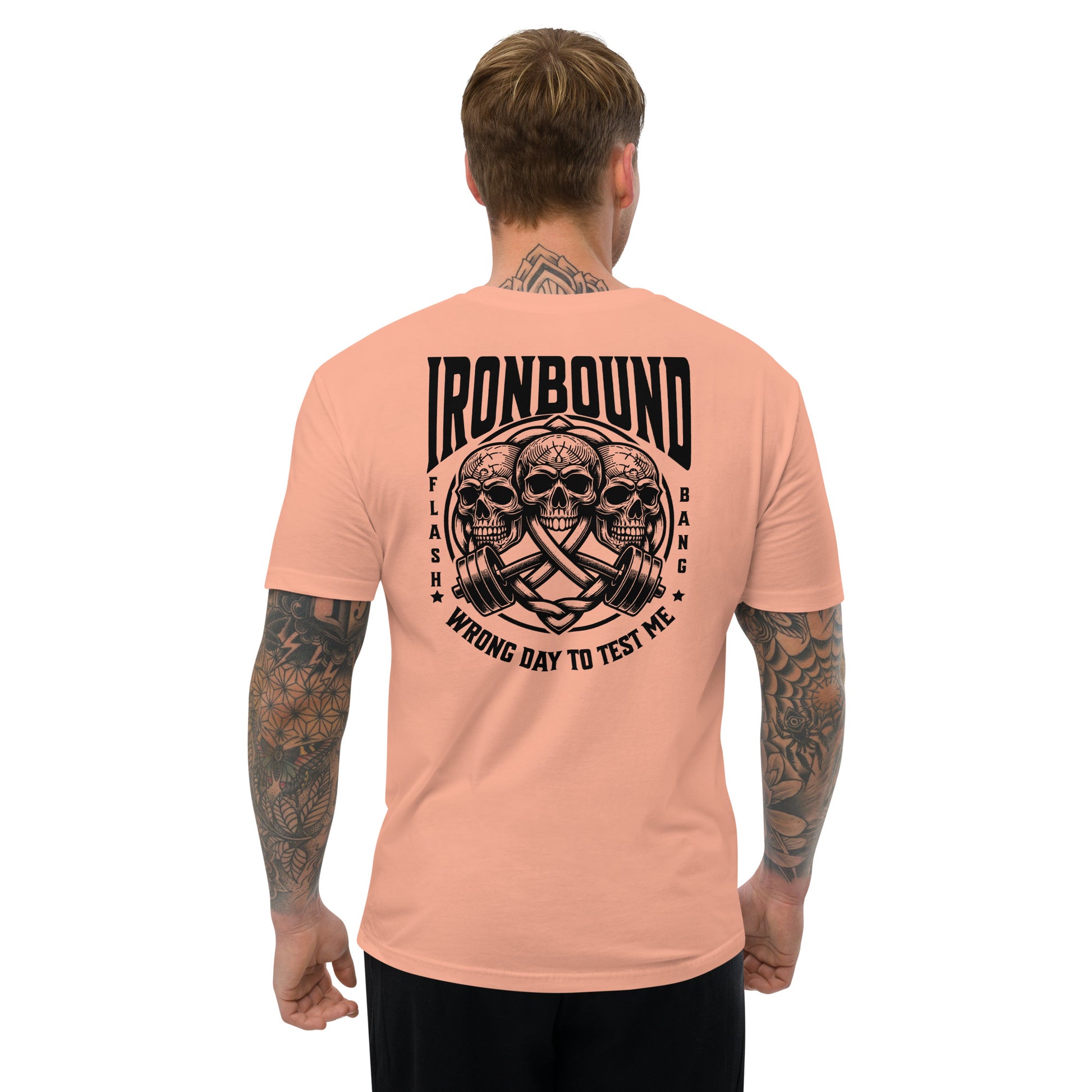 Man wearing a peach t-shirt with 'Ironbound' graphic design on the back, on a white background