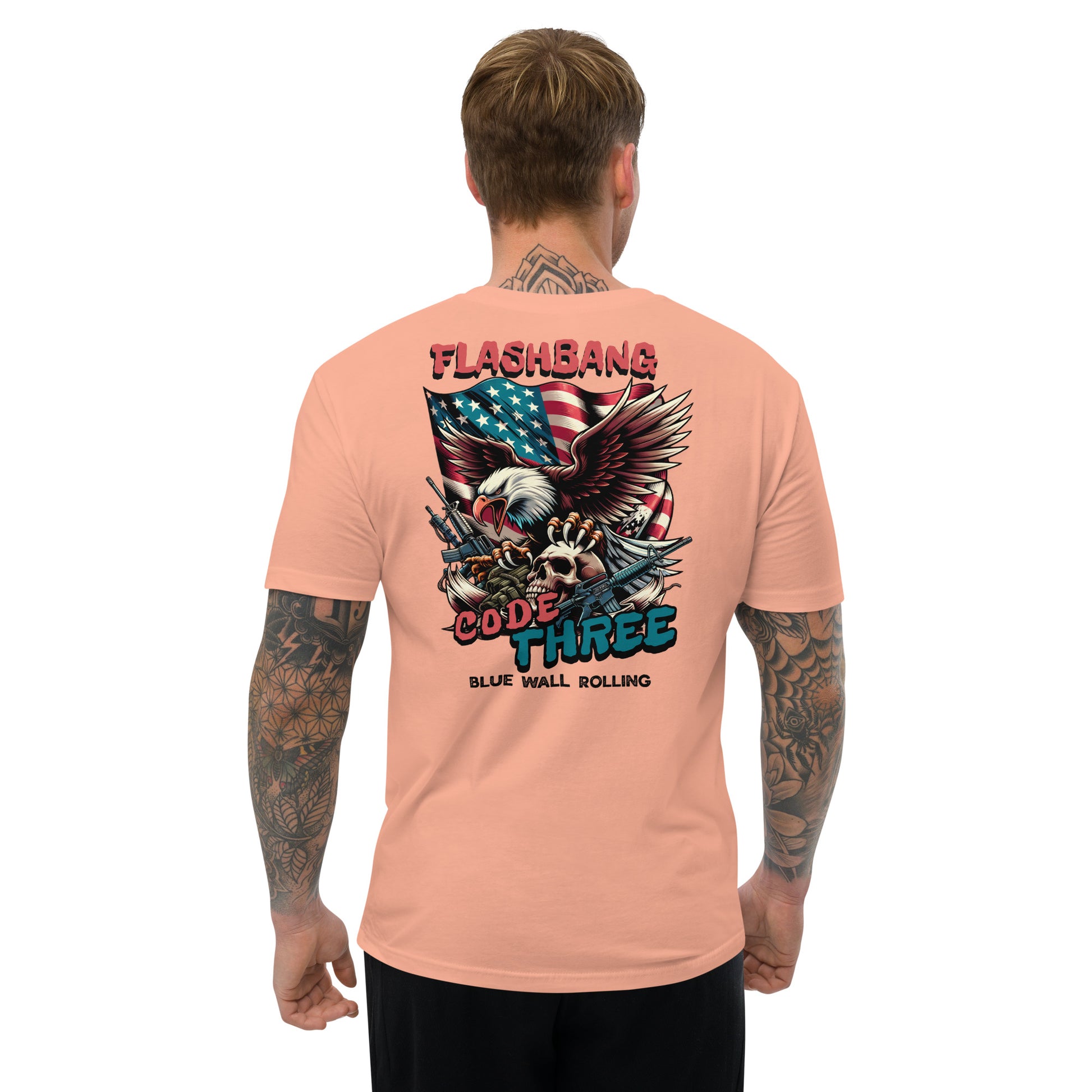 Man wearing a peach t-shirt with a graphic design on the back, featuring an eagle and text.