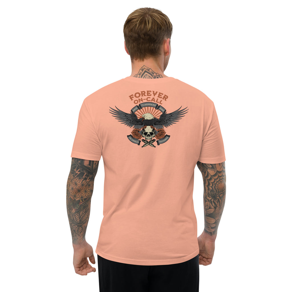 Man wearing a peach t-shirt with a graphic design on the back, featuring an eagle and skull, on a white background.
