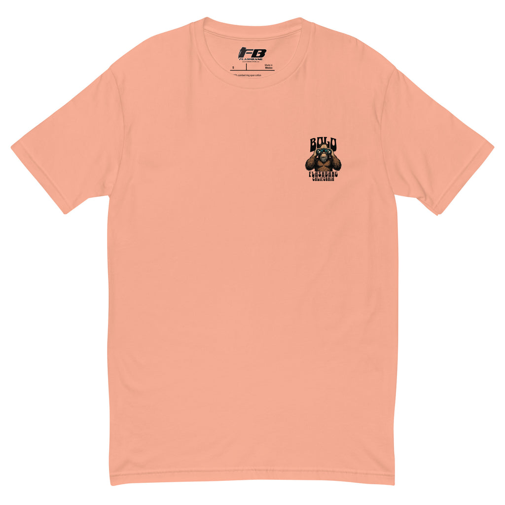 Peach t-shirt with a small graphic on the chest against a white background
