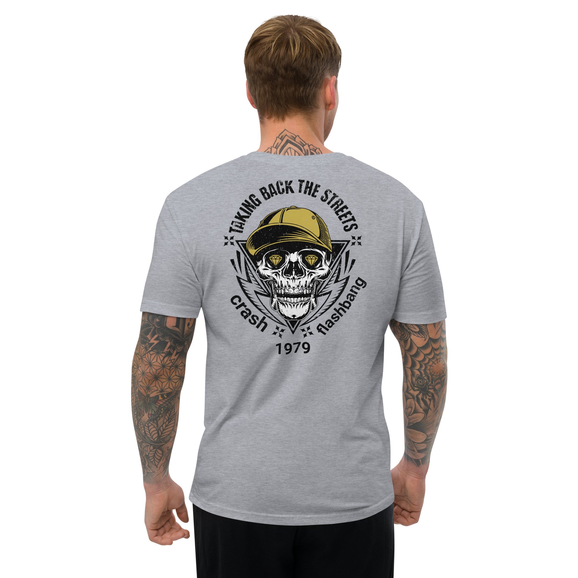 Gray t-shirt with a skull and cap graphic on the back, worn by a person.