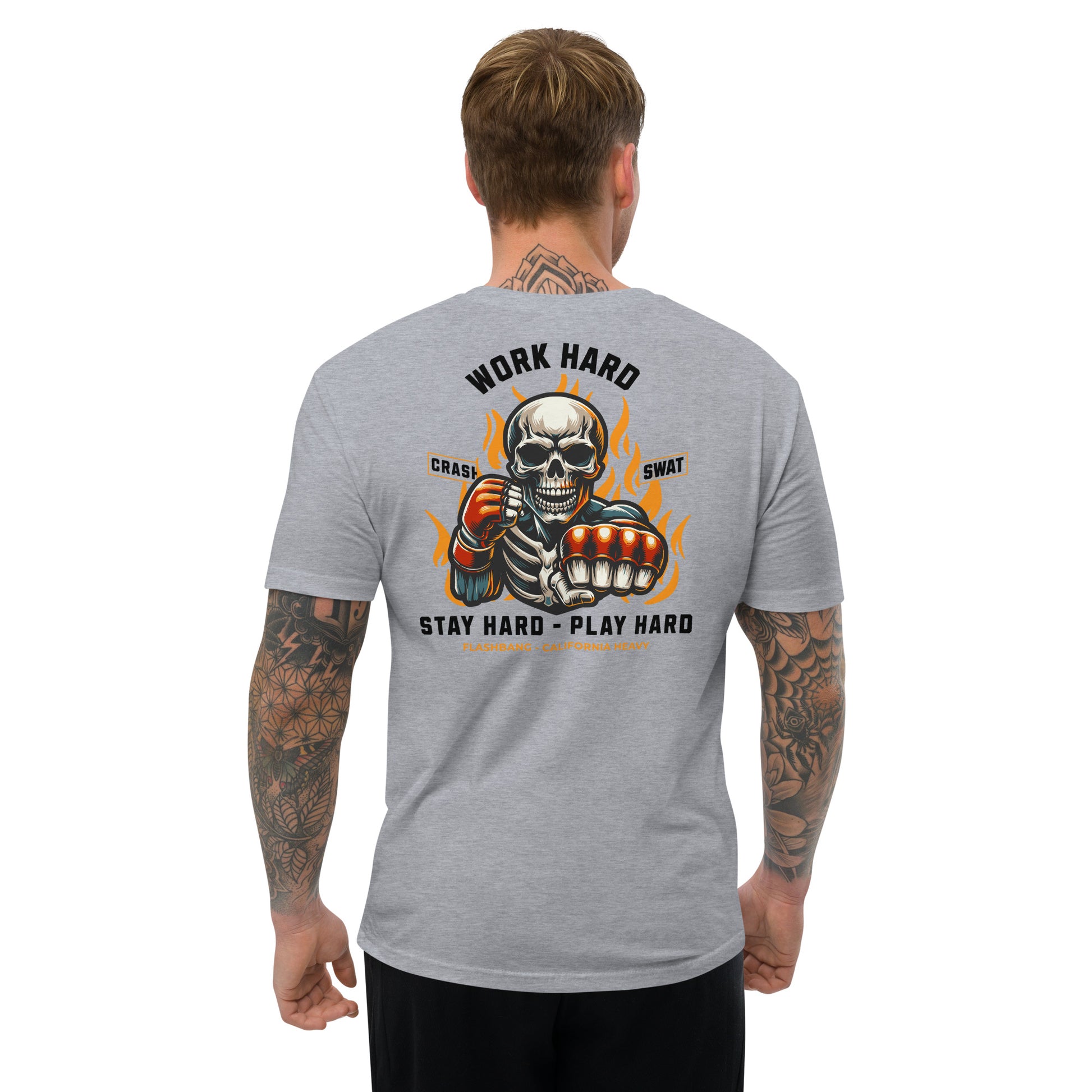 Gray t-shirt with a graphic design on the back, featuring a skeleton and text, worn by a person.