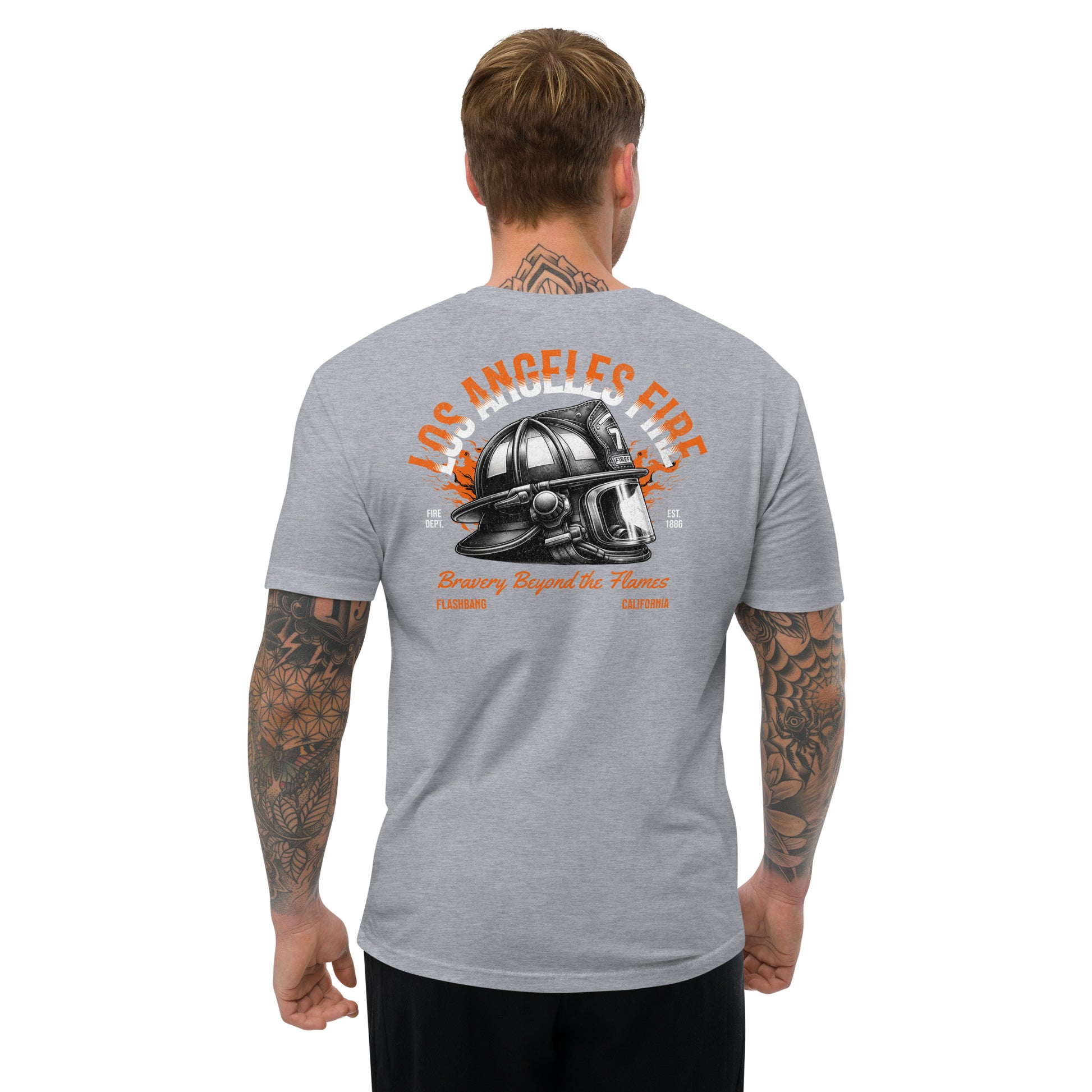 Man wearing a gray t-shirt with a graphic design on the back, featuring text and a helmet.