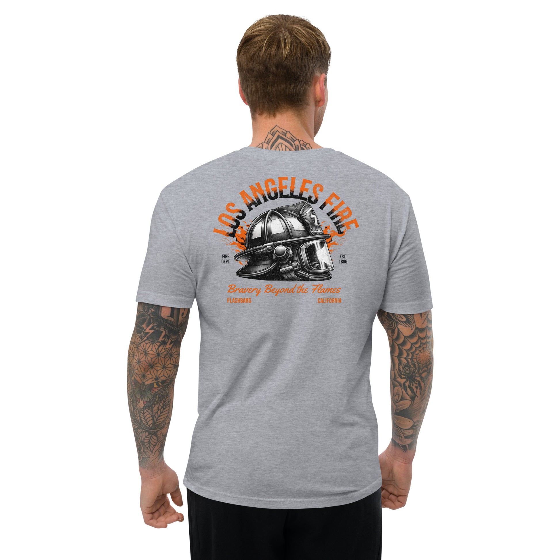 Man wearing a gray t-shirt with a fire helmet graphic and text on the back, on a white background.