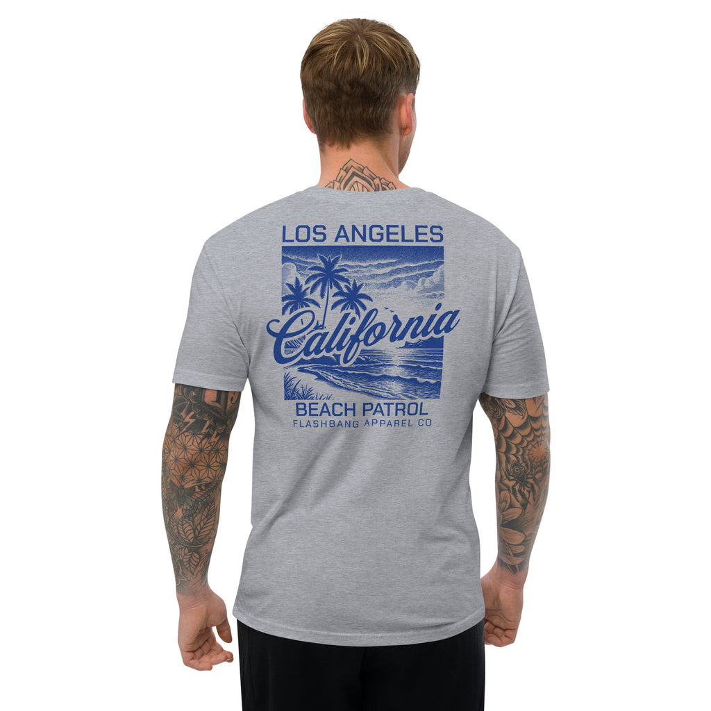 Man wearing a gray t-shirt with 'Los Angeles California Beach Patrol' design on a white background