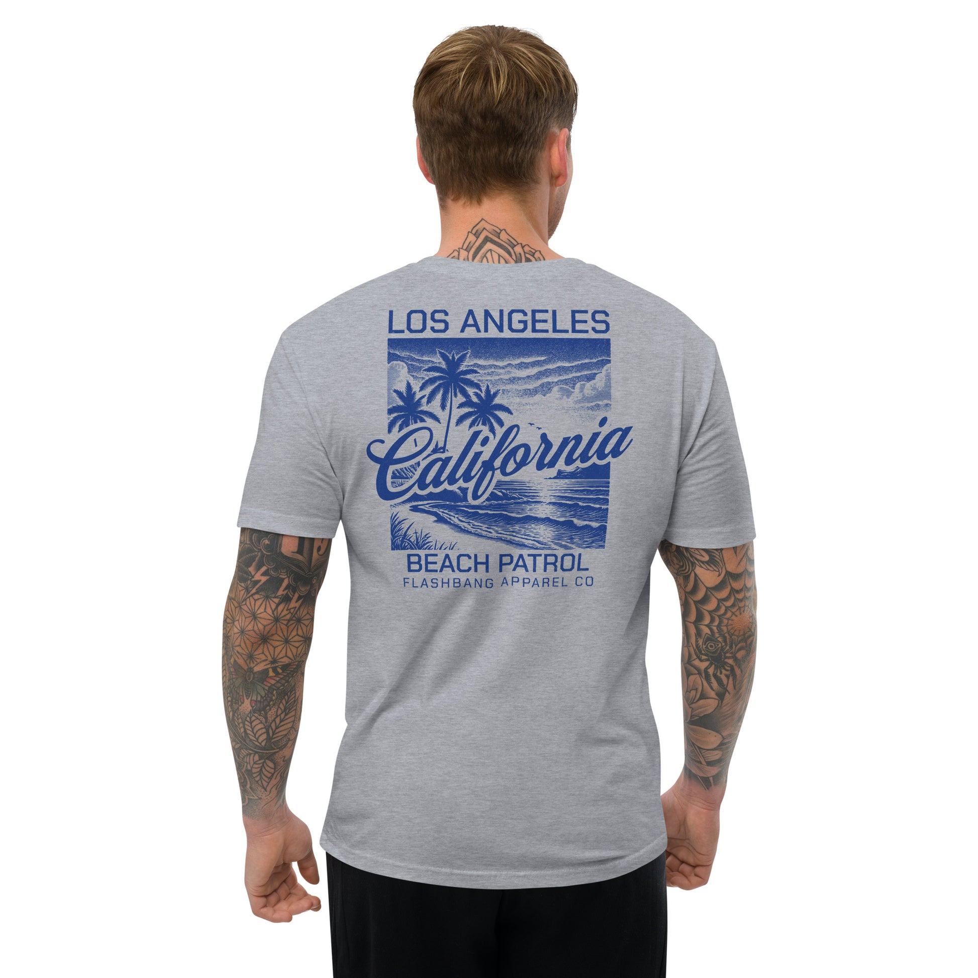 Man wearing a gray t-shirt with 'Los Angeles California Beach Patrol' design on a white background
