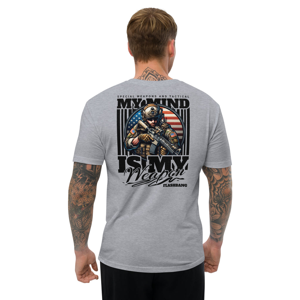 Gray t-shirt with graphic design on the back, featuring a soldier and text, worn by a person.