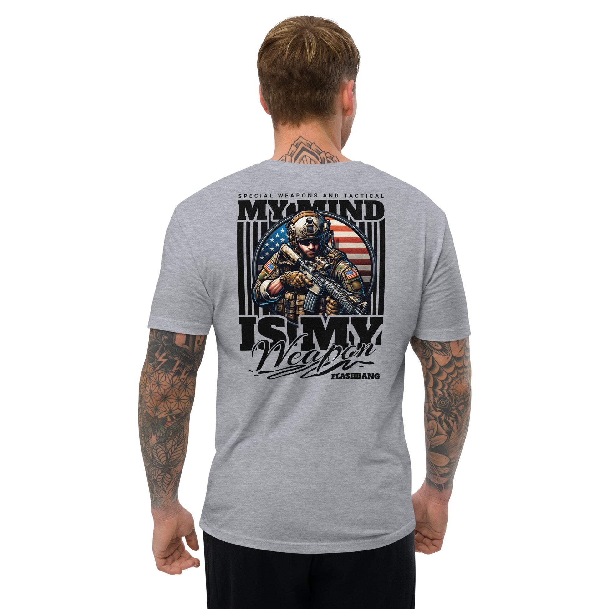 Gray t-shirt with graphic design on the back, featuring a soldier and text, worn by a person.