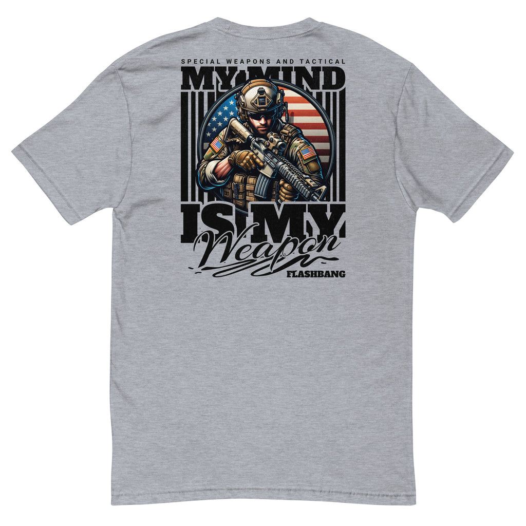 Gray t-shirt with a graphic design featuring a soldier and American flag, text 'My Mind is My Weapon', on a white background.