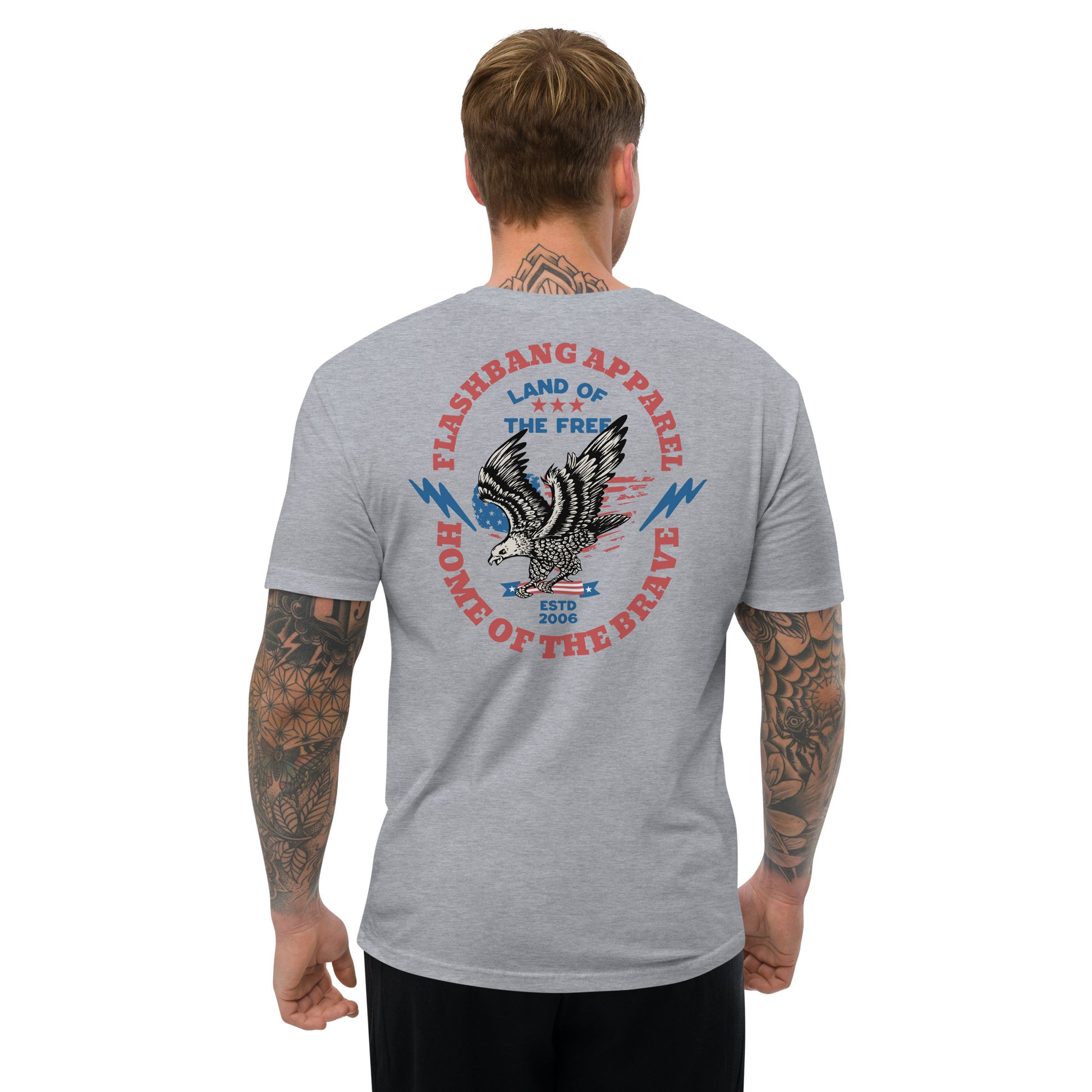 Man wearing a gray t-shirt with an eagle graphic and text on the back, on a white background