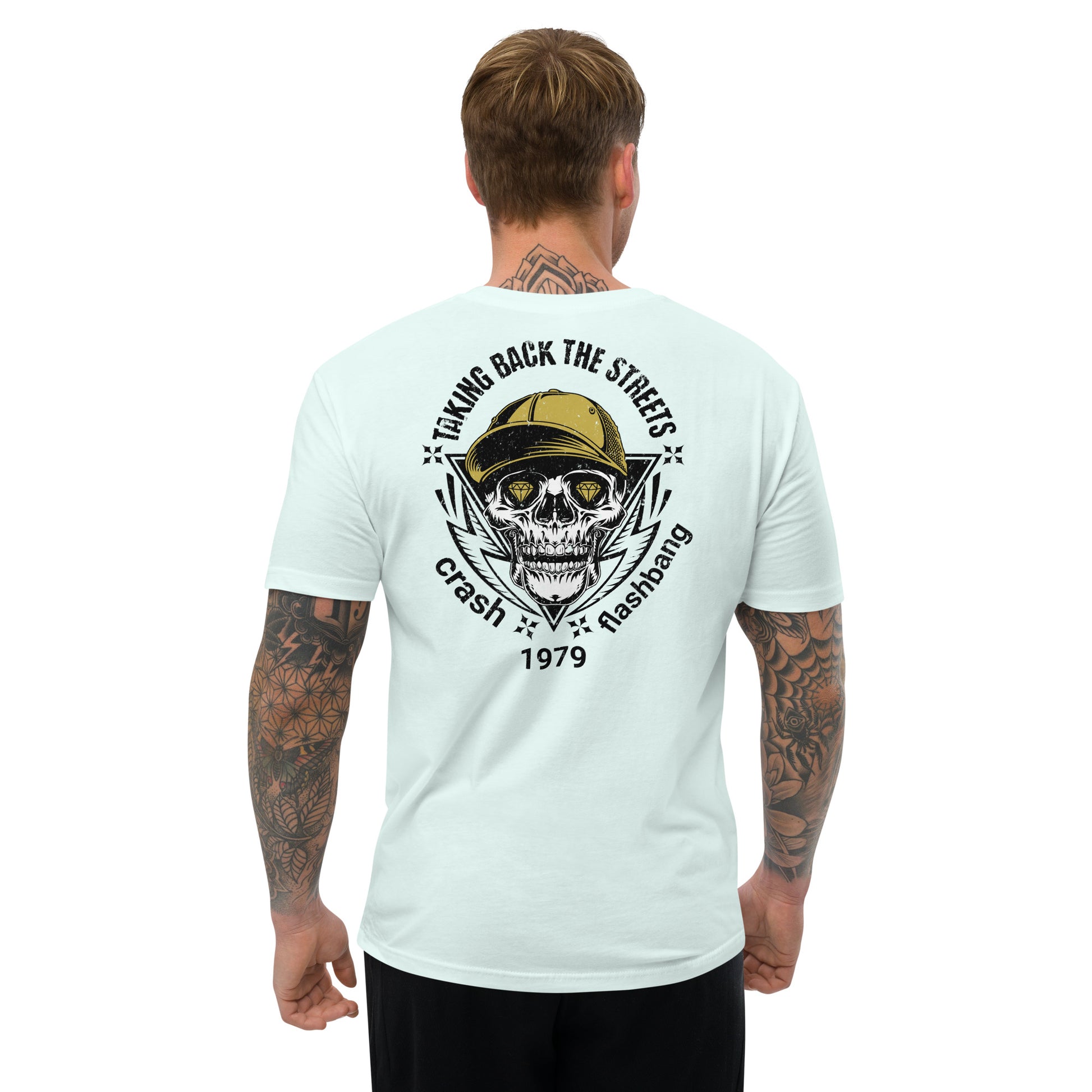 Man wearing a light blue t-shirt with a skull graphic and text on the back, on a white background.
