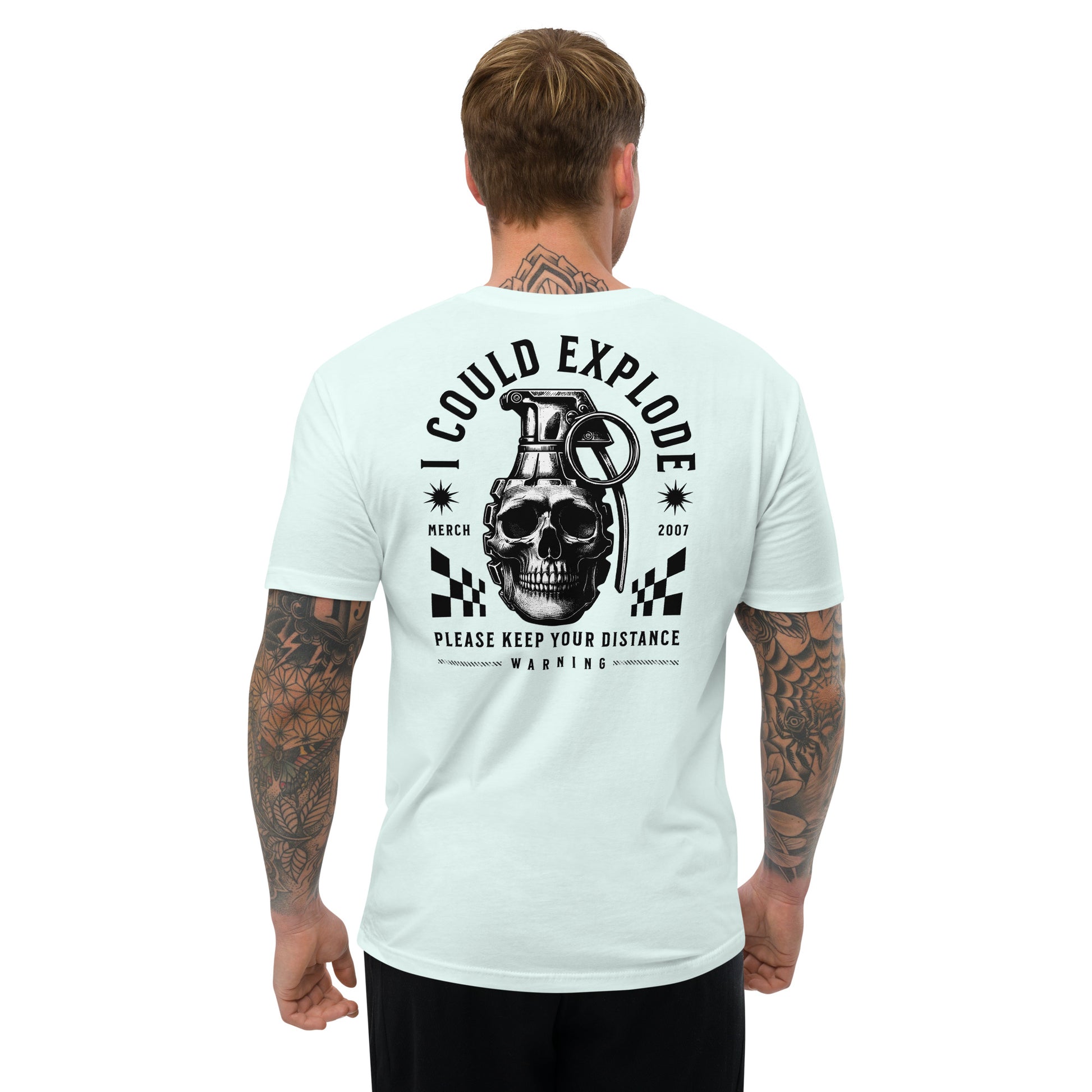Man wearing a light blue t-shirt with a graphic design on the back, featuring a skull and grenade.