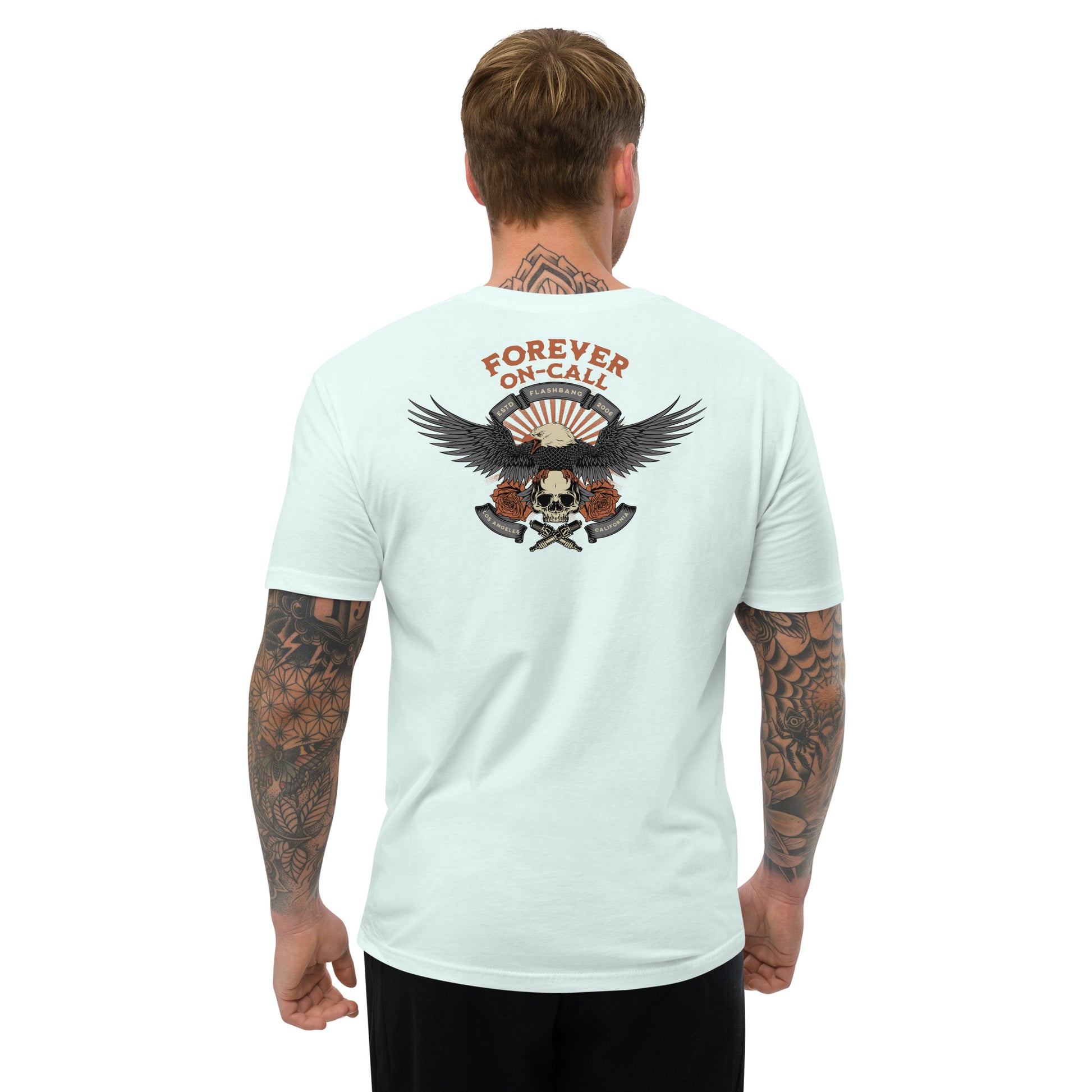 Man wearing a light blue t-shirt with a graphic design on the back, featuring an eagle and skull, on a white background.