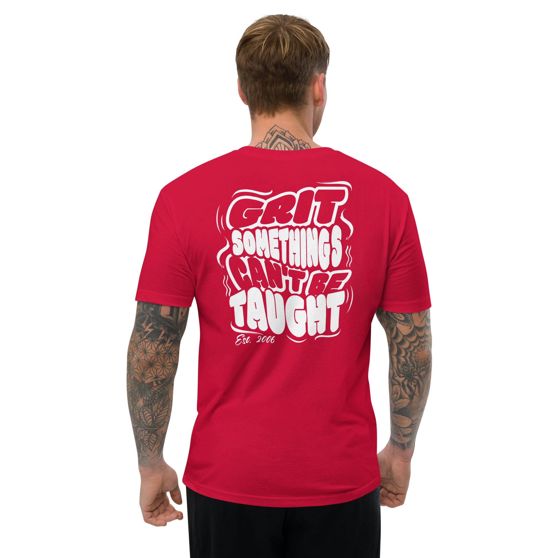 Man wearing a red t-shirt with white text on the back, standing against a white background