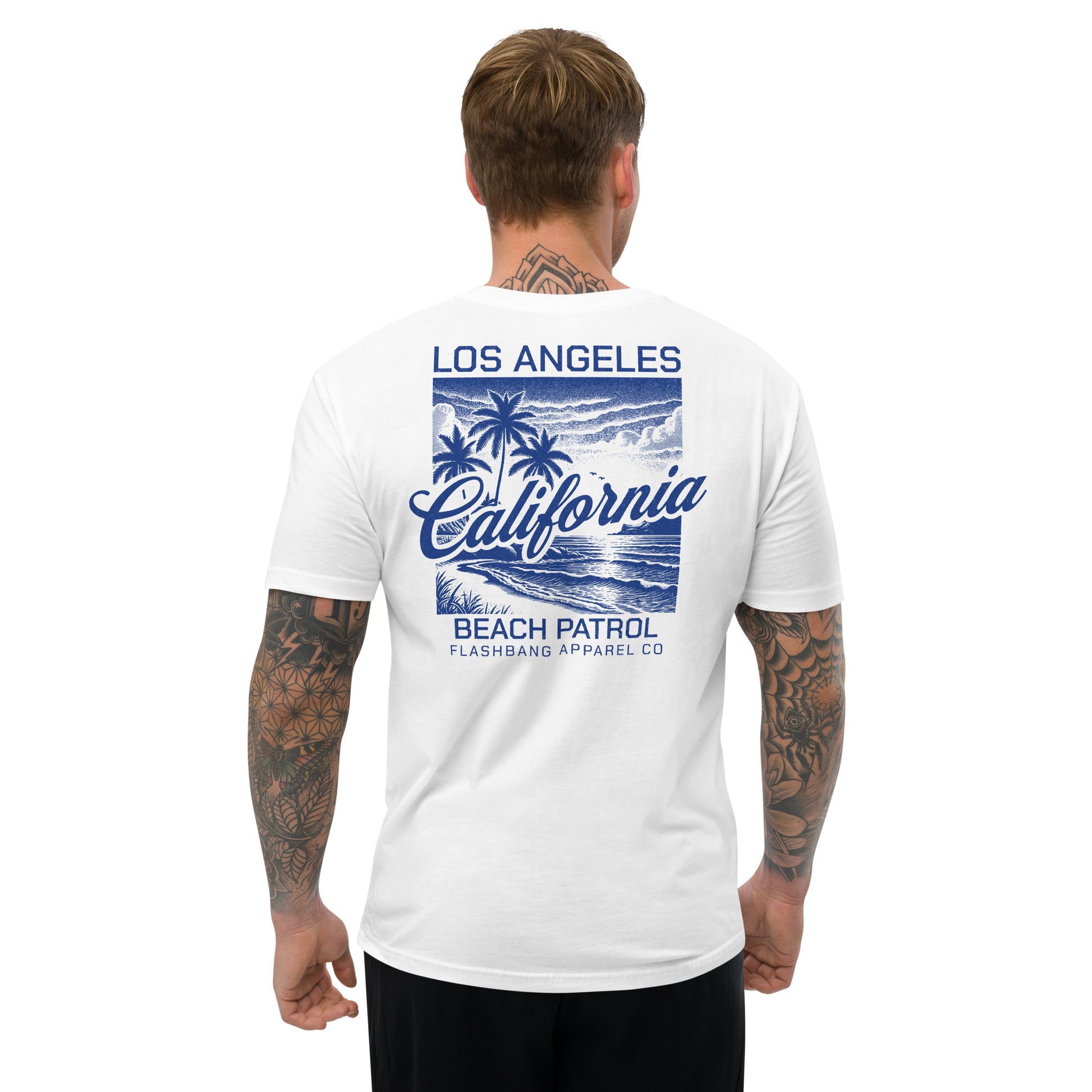 Man wearing a white t-shirt with 'Los Angeles California Beach Patrol' design on the back.