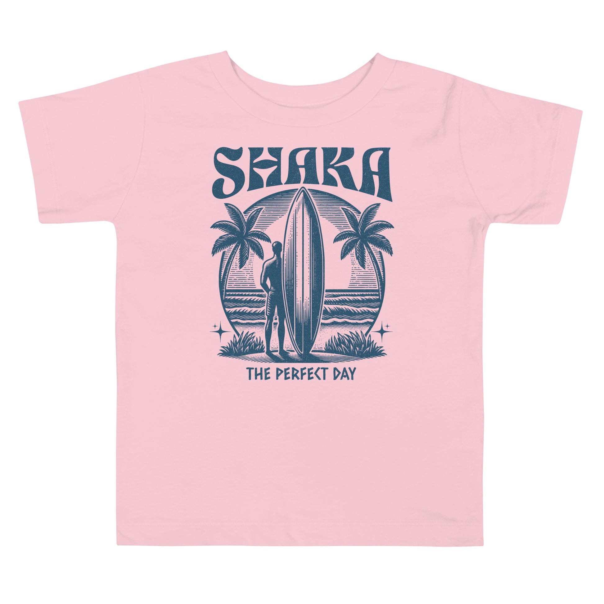 Pink t-shirt with a graphic design of a surfer, palm trees, and the text 'Shaka The Perfect Day' on a white background.