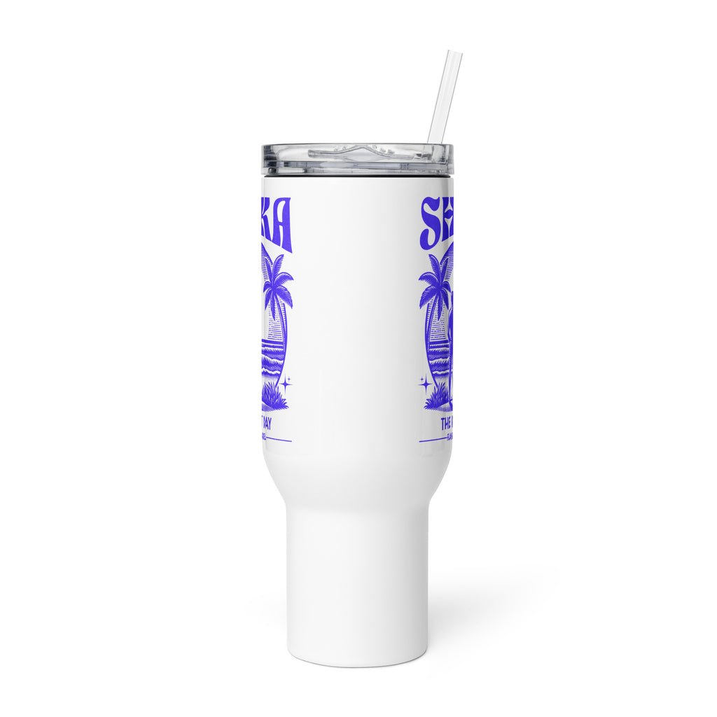 White tumbler with blue palm tree design and straw on a white background