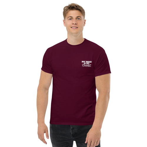 Man wearing a maroon t-shirt with a logo on a white background