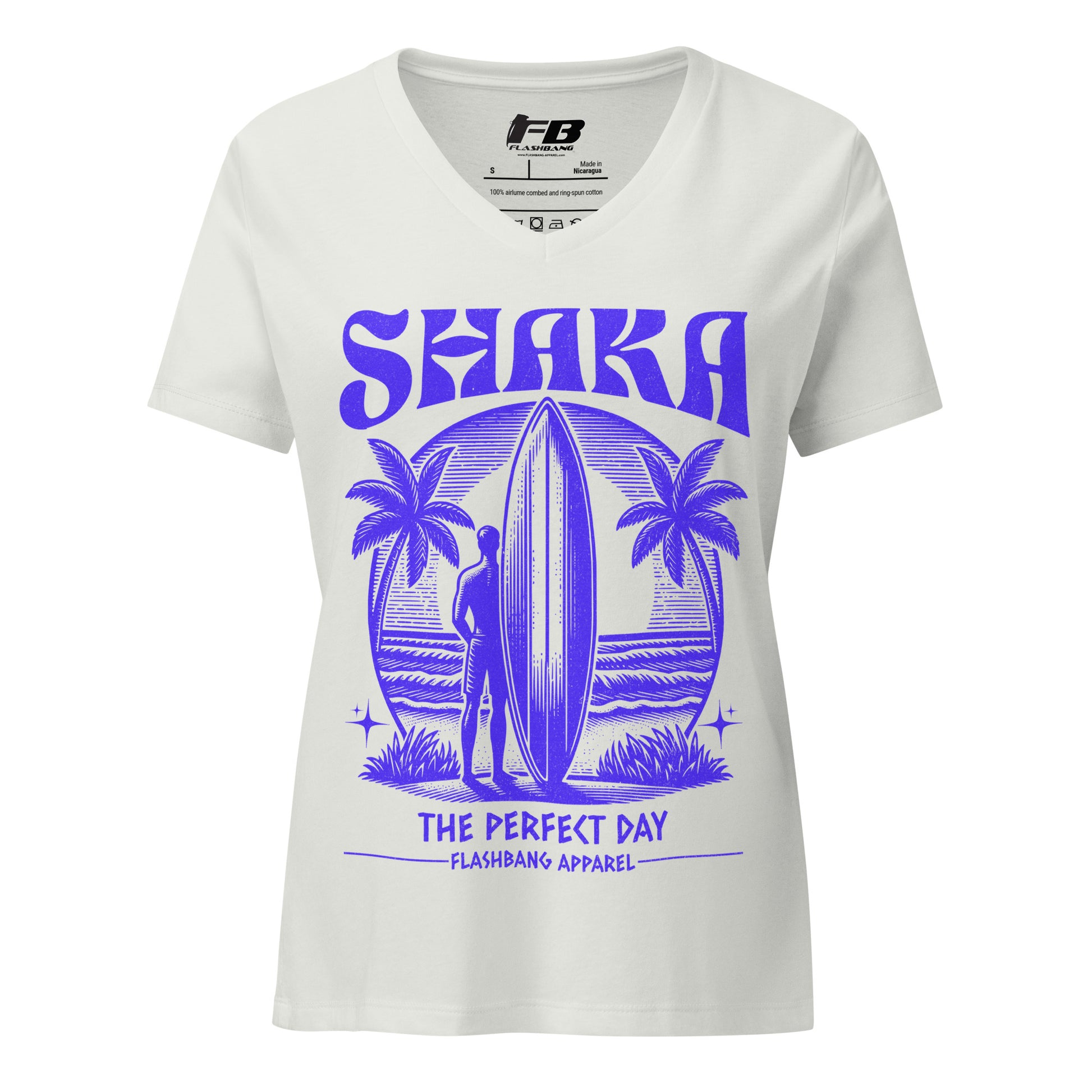White t-shirt with purple 'Shaka' graphic design featuring a surfer and palm trees, branded with Flashbang Apparel.