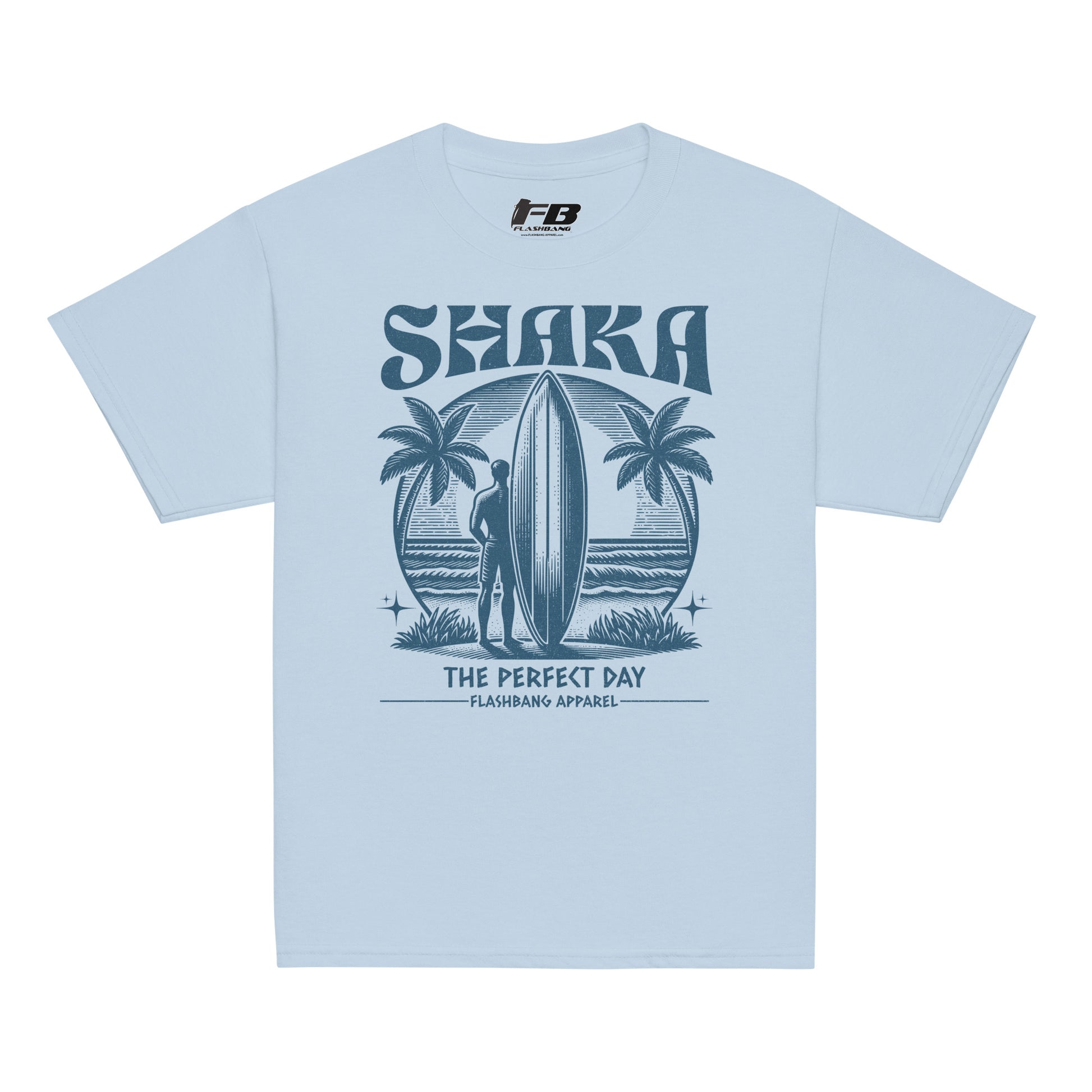 Light blue t-shirt with a graphic design of a surfer and palm trees, featuring the text 'Shaka The Perfect Day' on a white background.